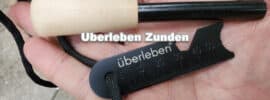 man holding Uberleben Zunden ferro rod fire starter in his hand